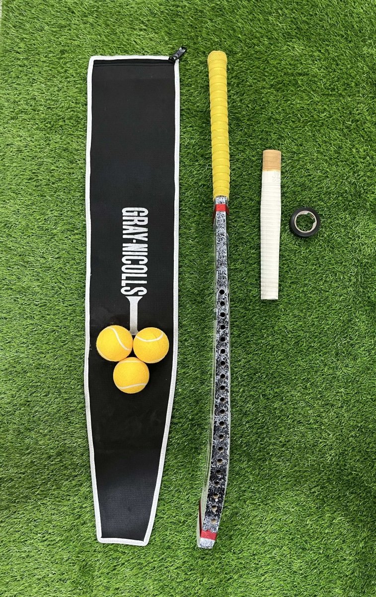 Jd Cricket bat  balls, and a Cricket bat Handle grip  on a green grass background